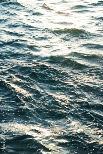 Surface of the sea with small waves of turquoise color.