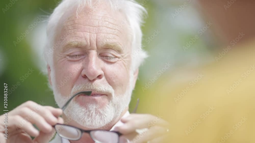 Senior affluent couple enjoying time together one morning at an outdoor cafe Senior affluent couple enjoying time together one morning at an outdoor cafe