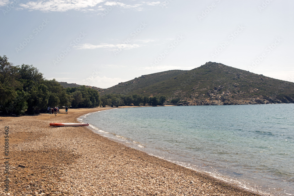 Obraz premium A view of a beach and a canoe in the beautiful island of Patmos, Greece in summer