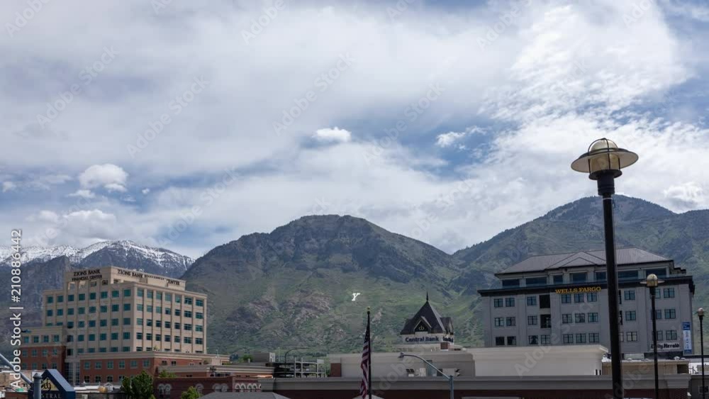 Time lapse viewing tops of buildings in downtown Provo Utah towards the mountains showing the Y. Time lapse viewing tops of buildings in downtown Provo Utah towards the mountains showing the Y.