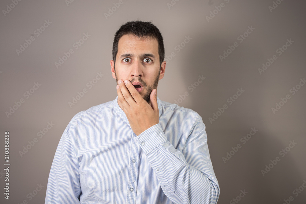 man with expression of amazement and hands on his head man with expression of amazement and hands on his head