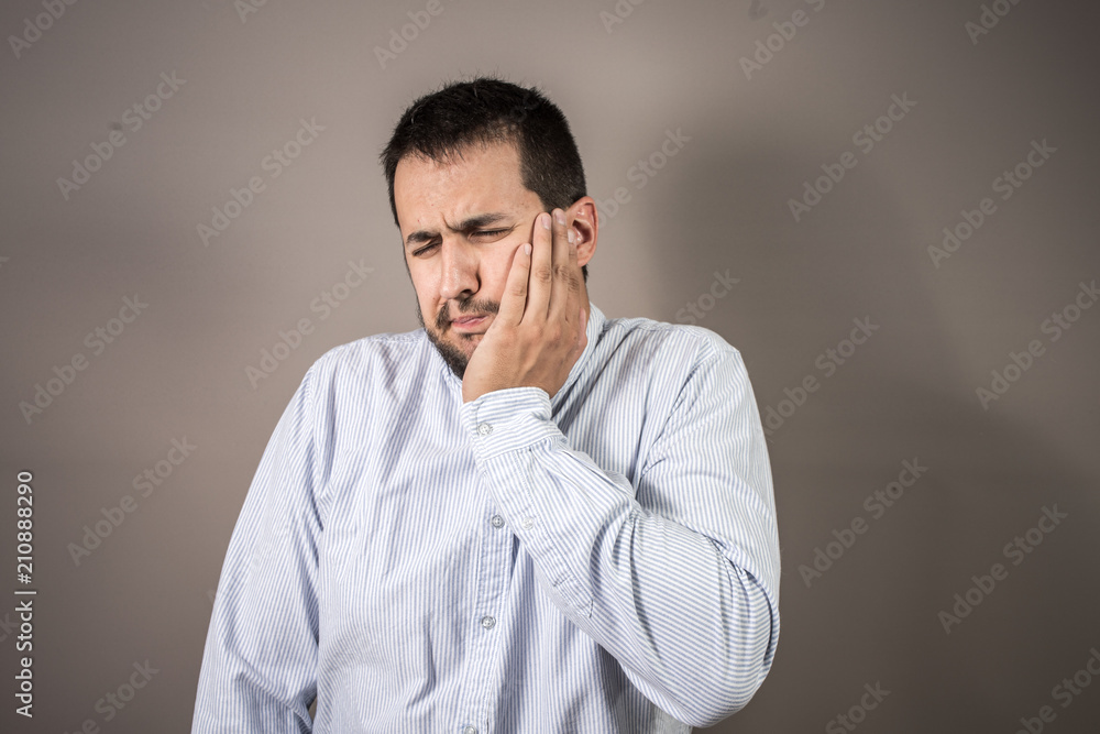 man in pain throwing his hand to his face man in pain throwing his hand to his face