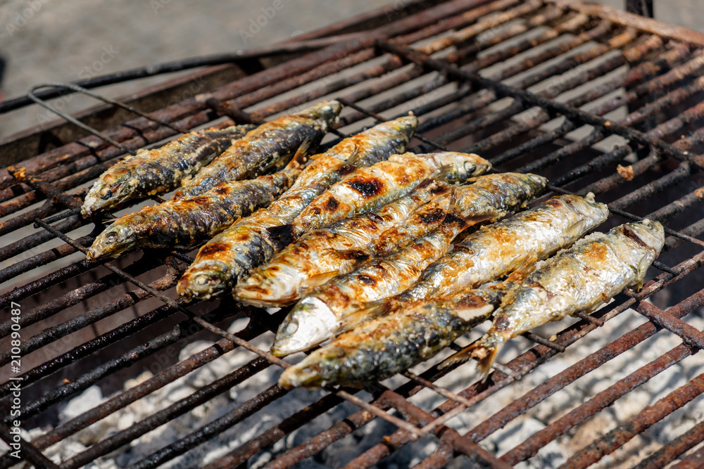 Grilled sardines and green peppers in Porto, Portugal on a grid grill