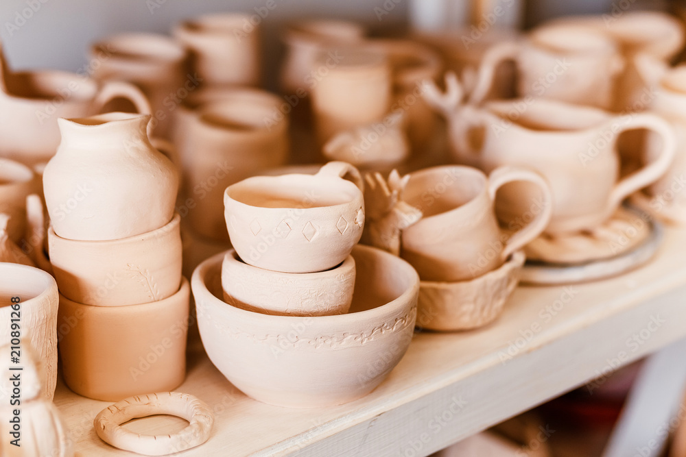 Empty clay pots drying on a shelf Empty clay pots drying on a shelf