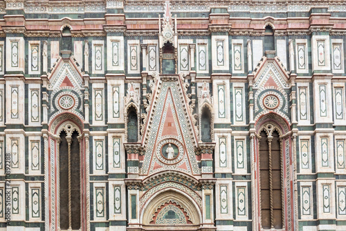 A close-up of the gothic marble facade of the Florence Duomo Cathedral in Italy.