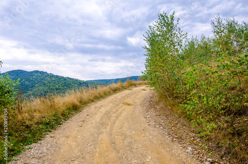 Unpaved rural road on a high mountain peak in Transylvania region of Romania