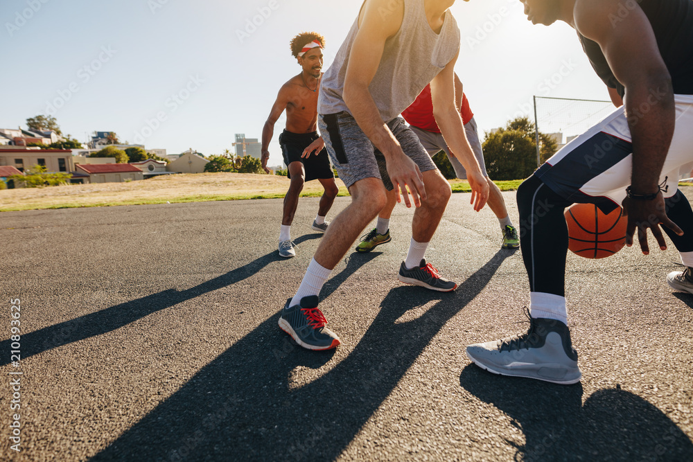 Naklejka premium Men playing basketball