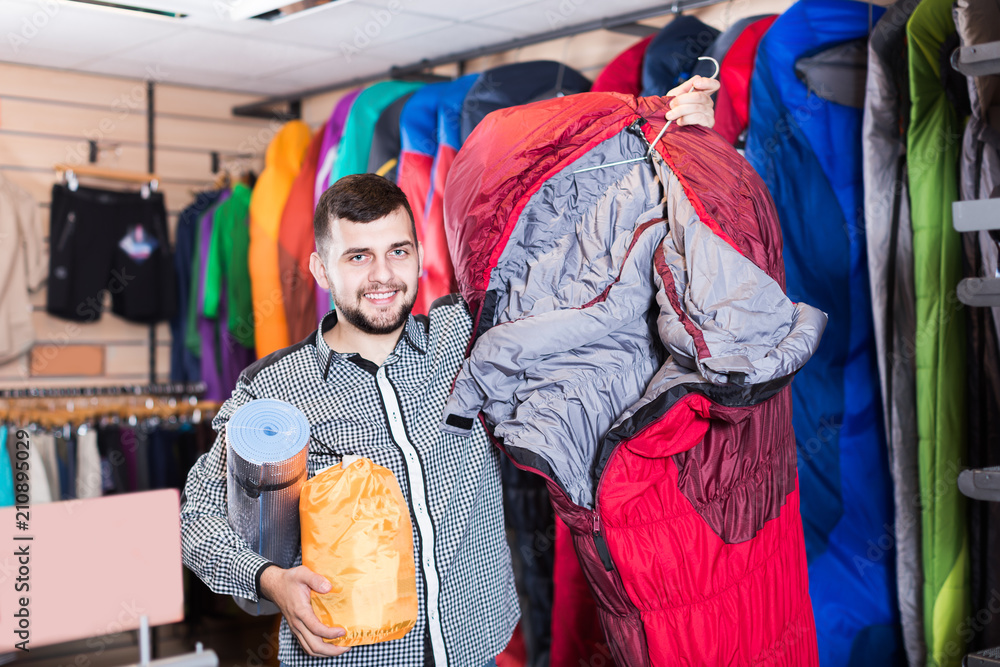 Obraz premium Adult customer examining touristic equipment