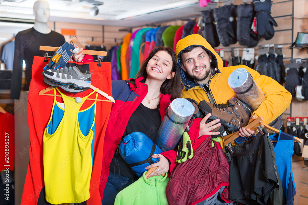 Fototapeta premium Young couple demonstrating tourist equipment