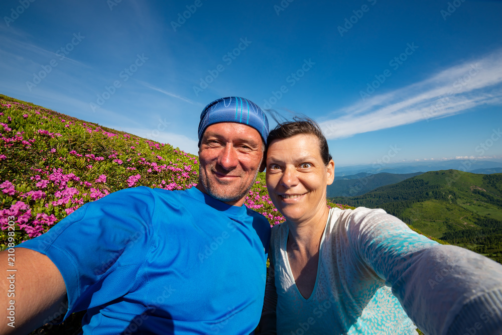 Joyful couple of adventurers taking selfie and having fun Joyful couple of adventurers taking selfie and having fun
