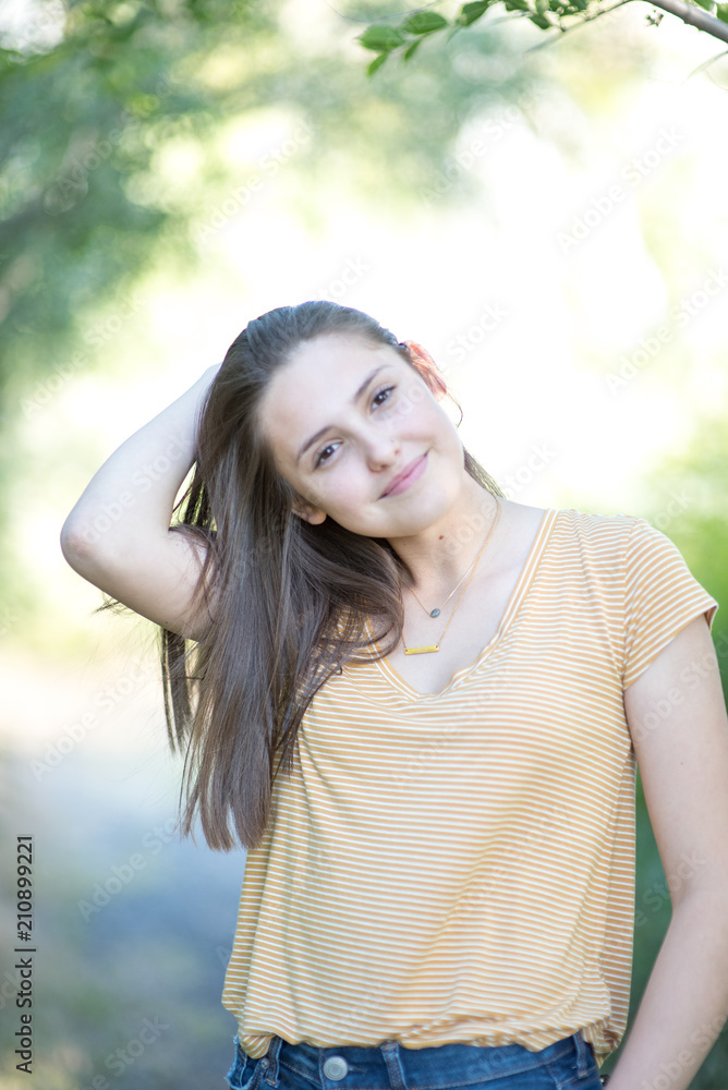 Beautiful teenage girl in a park setting