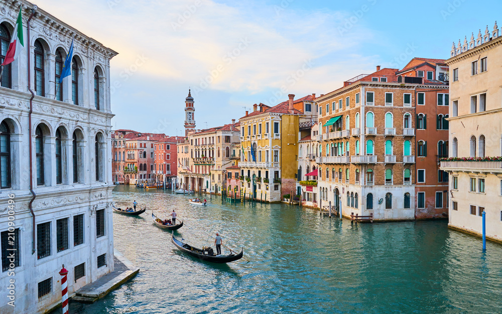 Obraz premium Canal Grande with boats and lights in Venice at Sunset. Next to famous Rialto Bridge and the Street 