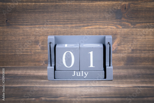 1 july wooden, square calendar. business trip or holiday planning background