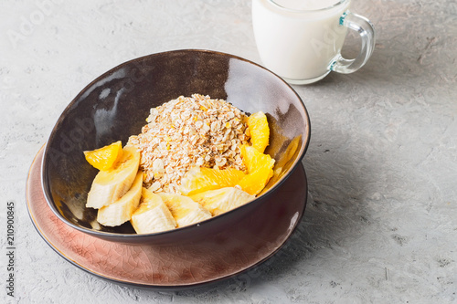 Oats Barley Wheat Rye Corn mix flake proper nutrition diet with pieces banana orange and glass of milk photo