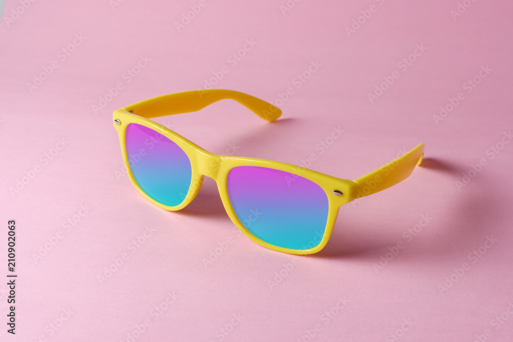 Yellow sunglasses on pastel pink background. Minimal summer concept.