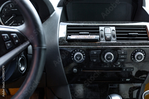 car interior. Modern car speedometer and dashboard. Luxurious car instrument cluster. © Georgii