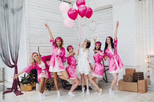 Bridesmaids and bride having fun at bachelorette party.