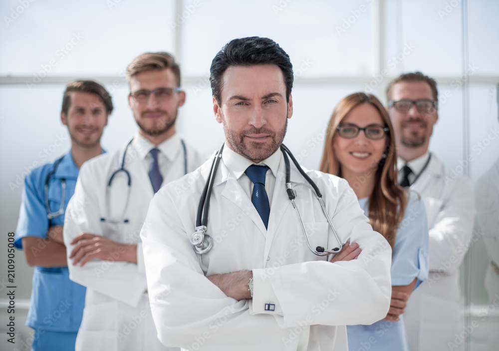 confident doctor on the background of colleagues confident doctor on the background of colleagues