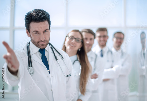 doctor is holding out his hand for a greeting
