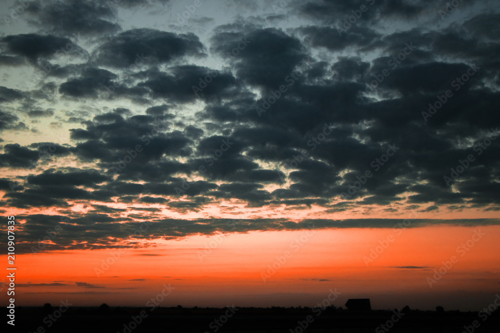 Fototapeta premium Red sunset and textured clouds