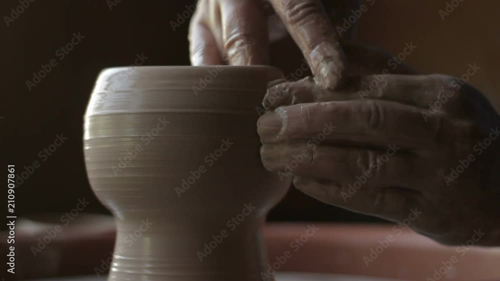creative process, inspiration. potter's hands making cup from wet clay on wheel creative process, inspiration. potter's hands making cup from wet clay on wheel