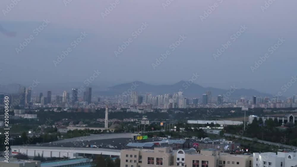 Time lapse of city skyline from day to night with some residential buildings and a shopping mall in frame. Time lapse of city skyline from day to night with some residential buildings and a shopping mall in frame.