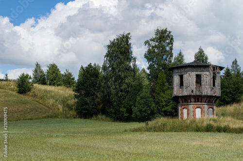 Old water tower at the railway station. Railway equipment for rail traffic service. photo