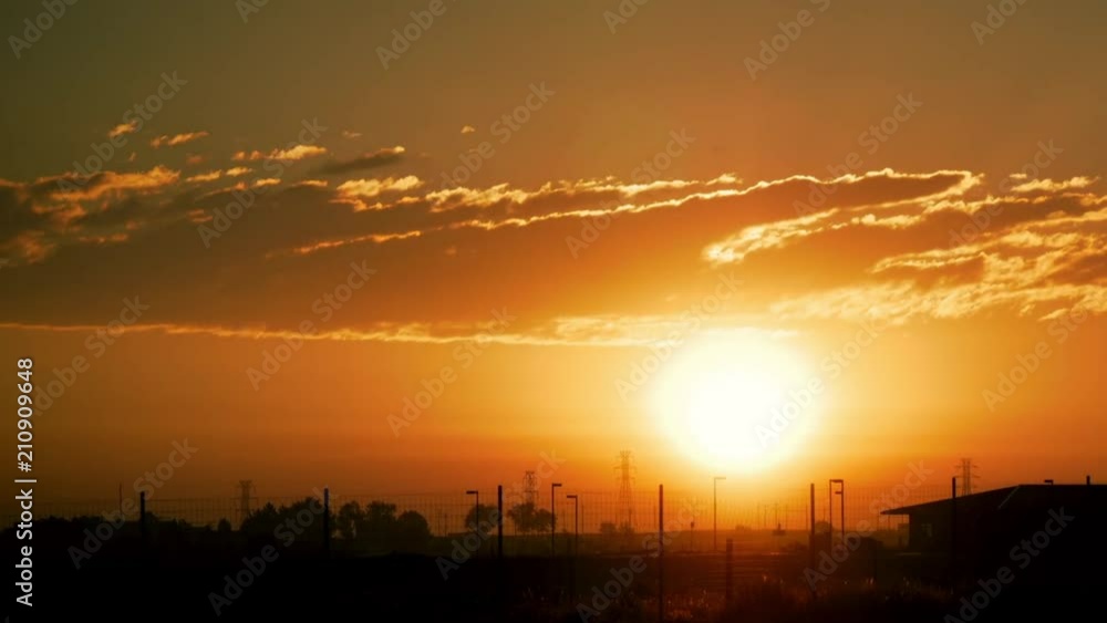 Brilliant Sunrise Time Lapse with Fence and Building Pan Right Brilliant Sunrise Time Lapse with Fence and Building Pan Right