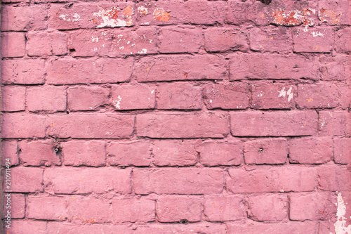 Red close up urban brick wall background of city building. Painted bricks of city house