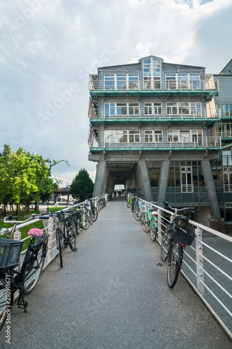 The lower panoramic and perspective view of steel blue glass skyscrapers, industrial architecture, business architecture with bicycle parking in the foreground. Germany, Hamburg. photo