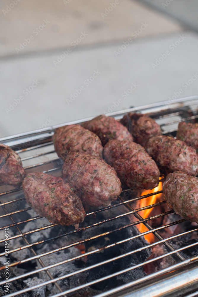 Lamb Kofta cooking on a charcoal grill Lamb Kofta cooking on a charcoal grill