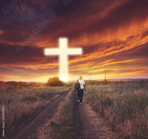 Light cross of Christ . Walk to the cross .  Sunbeams and cross . Sunset Man of Prayerfulness photo