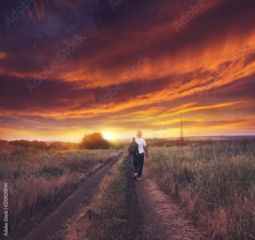 Happy woman  .  the woman going to a decline . foot walk with a backpack .Sunbeams and cross . Sunset Man of Prayerfulness photo