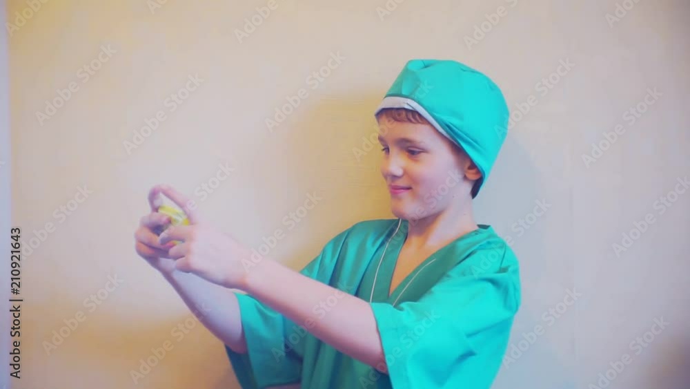 boy in doctor suit with a smartphone in the hands of boy in doctor suit with a smartphone in the hands of
