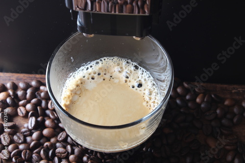 coffee glass coffee beanson a stone background a coffee machine photo