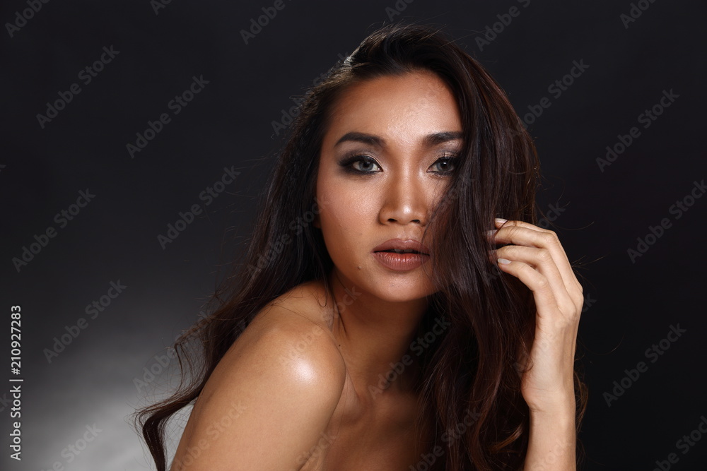 Fototapeta premium Asian Long straight black hair tan skin woman in Black dress