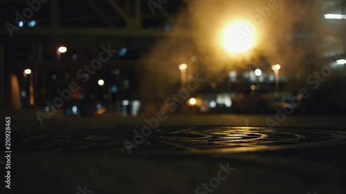 Cinematic City Shot At Night With Steam Rising From A Grate. photo