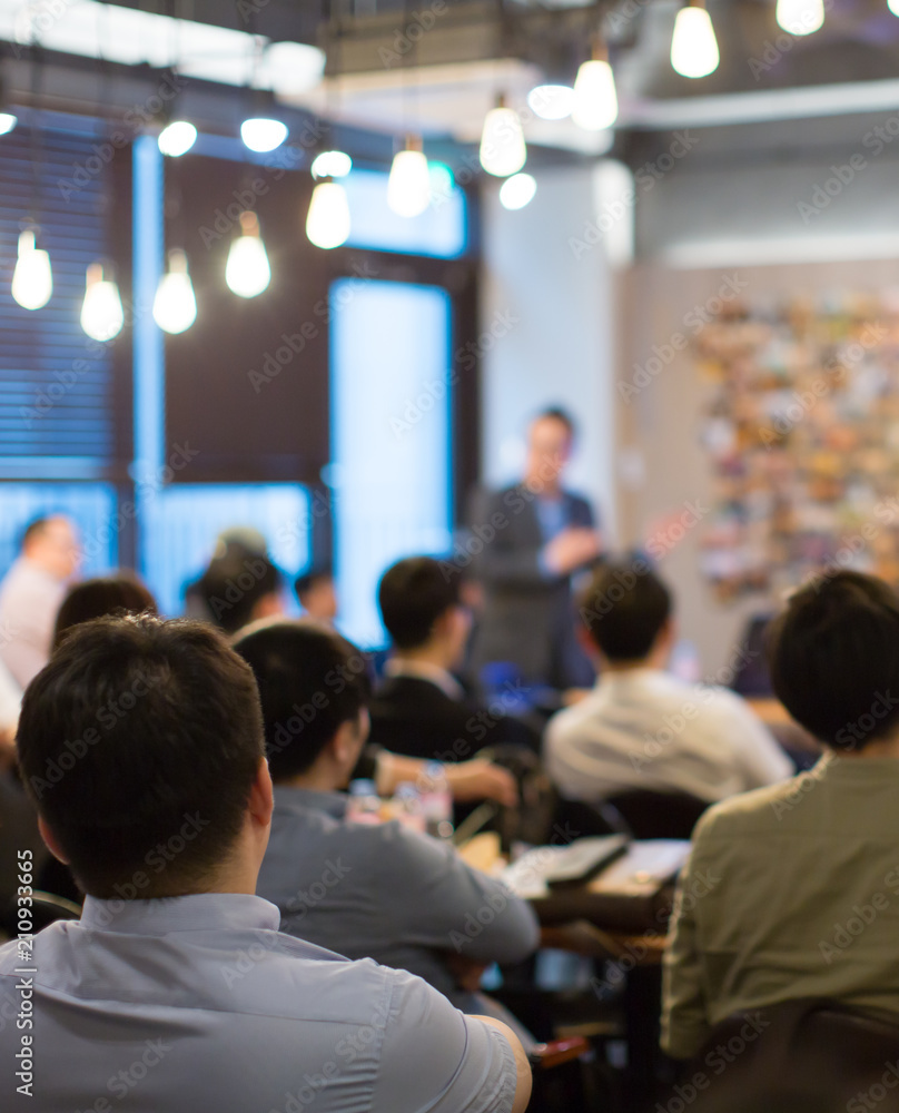 © Right 3 - Presenter Presenting on Stage at Conference Meeting. Professional Lecture. Blurred De-focused Unidentifiable Presenter and Audience. Corporate Executive Manager Speaker. People Attendees