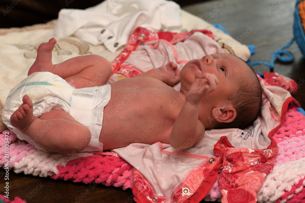 Beautiful Newborn Baby Girl Getting Ready for Her Mom to Change Her