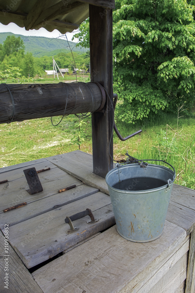 Bucket of water on a wooden well