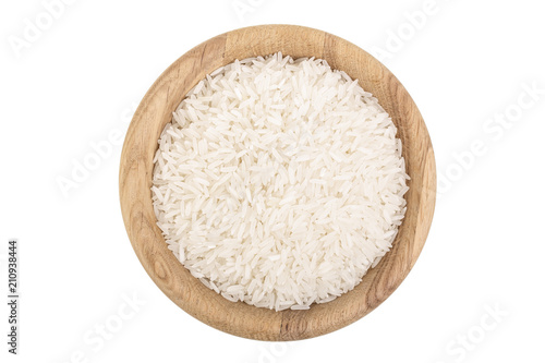 rice grains in wooden bowl isolated on white background. Top view. Flat lay