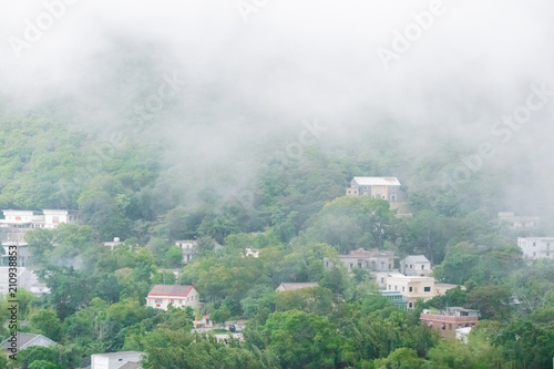 Canvas Print A traditional home on the hillside with fog around in HongKong