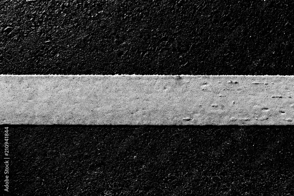 Fototapeta premium dirty white line on surface of old asphalt in countryside