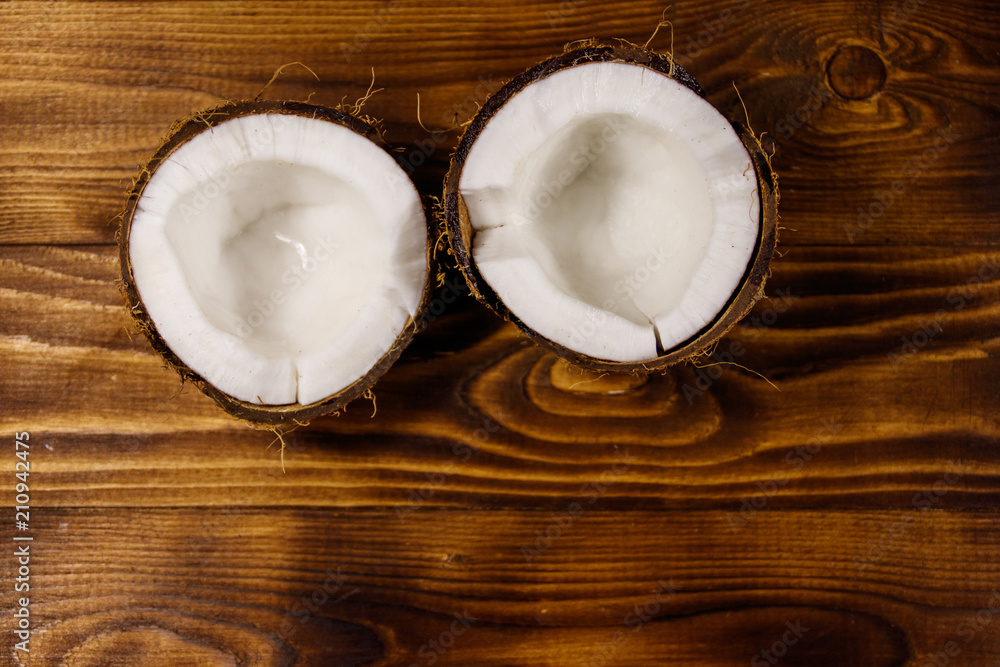 Fresh ripe coconut on rustic wooden table Fresh ripe coconut on rustic wooden table