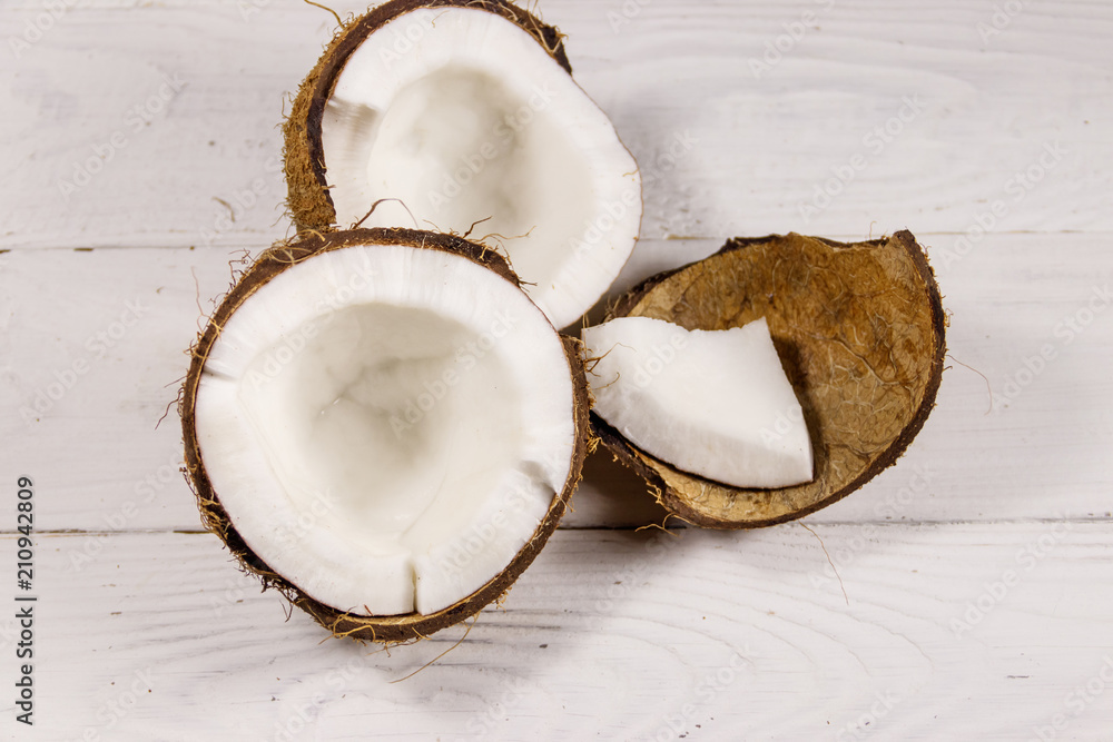 Fresh ripe coconut on white wooden table Fresh ripe coconut on white wooden table