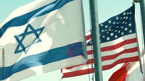 An Israeli and American Flag Blow in the Wind in slow motion