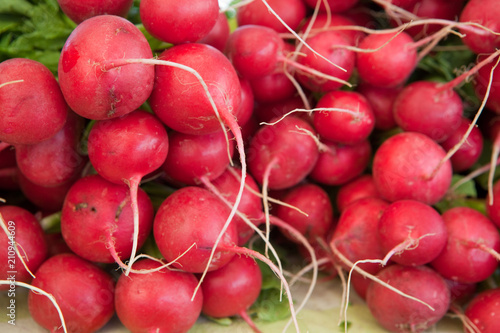 Stack of Fresh Red Radishes at a Farmers Market