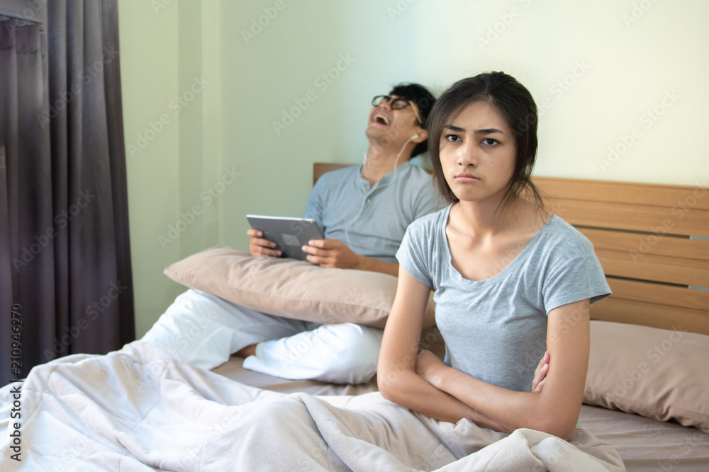Unhappy couple having conflict In bed in bed at home. Unhappy couple having conflict In bed in bed at home.
