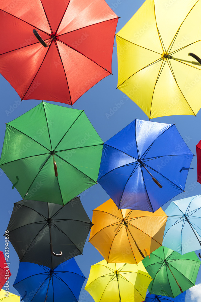 Colorful umbrellas on a blue sky background Colorful umbrellas on a blue sky background