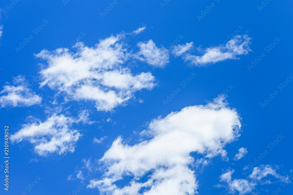 Obraz premium White fluffy clouds in a deep blue sky